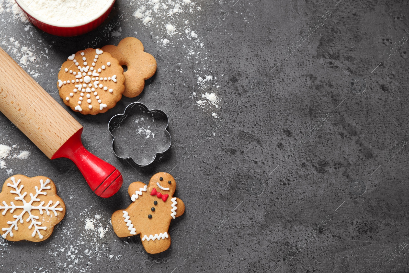 Photo of Flat lay composition with tasty homemade Christmas cookies on dark grey table, space for text