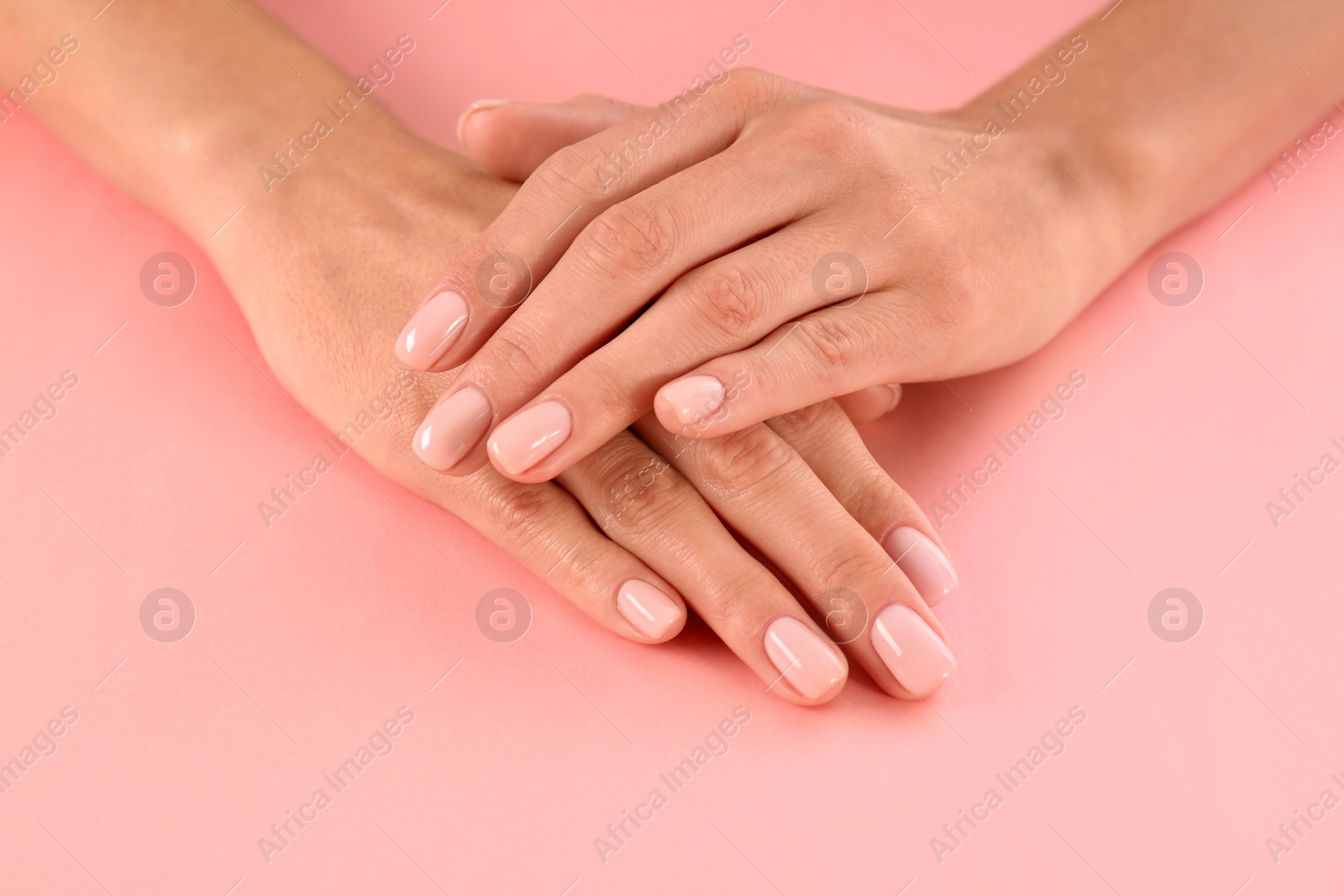 Photo of Closeup view of woman with beautiful hands on color background. Spa treatment