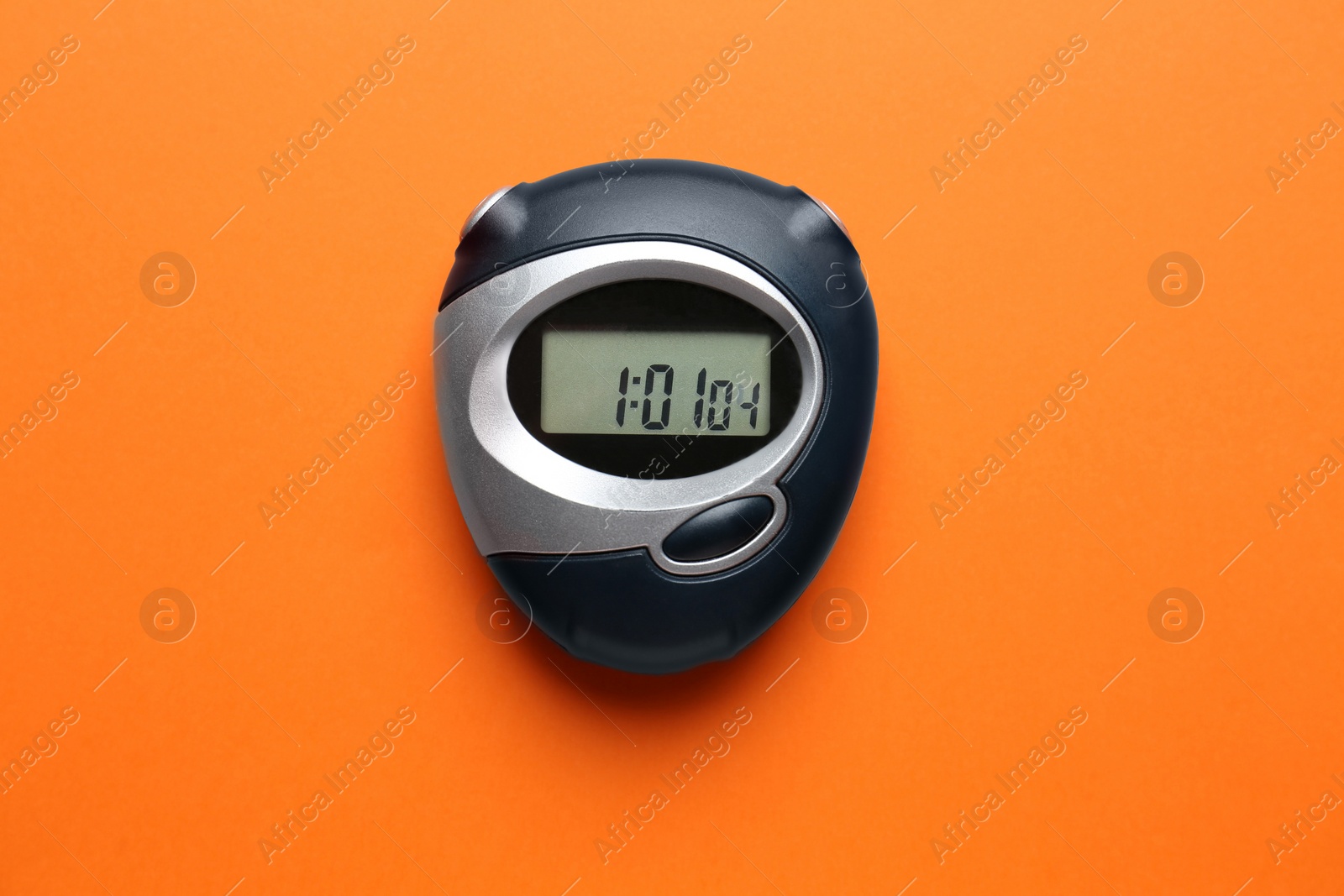 Photo of Digital timer on orange background, top view