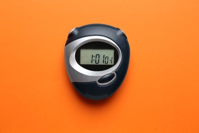 Photo of Digital timer on orange background, top view