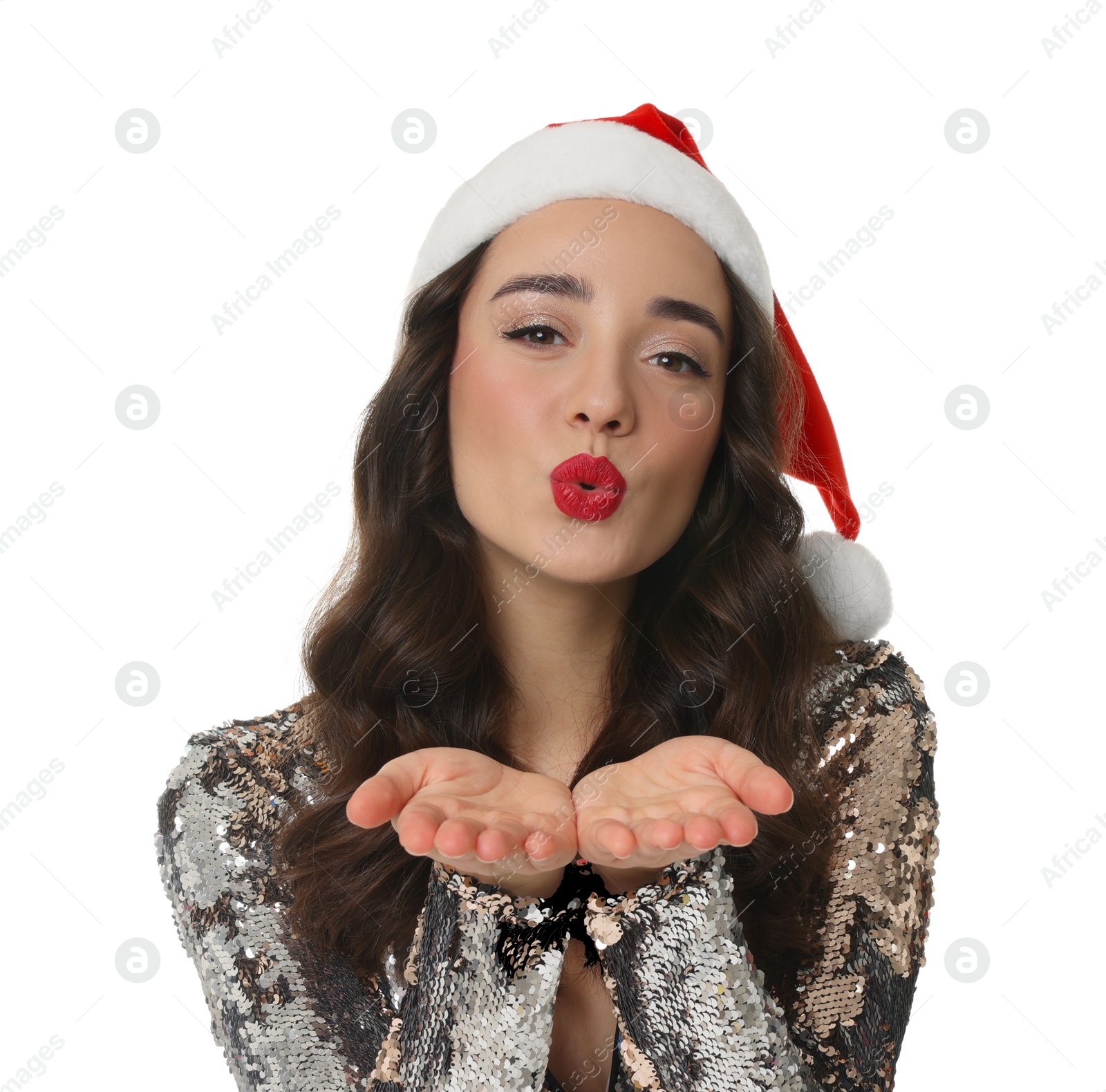 Photo of Christmas celebration. Beautiful young woman in Santa hat blowing kiss on white background