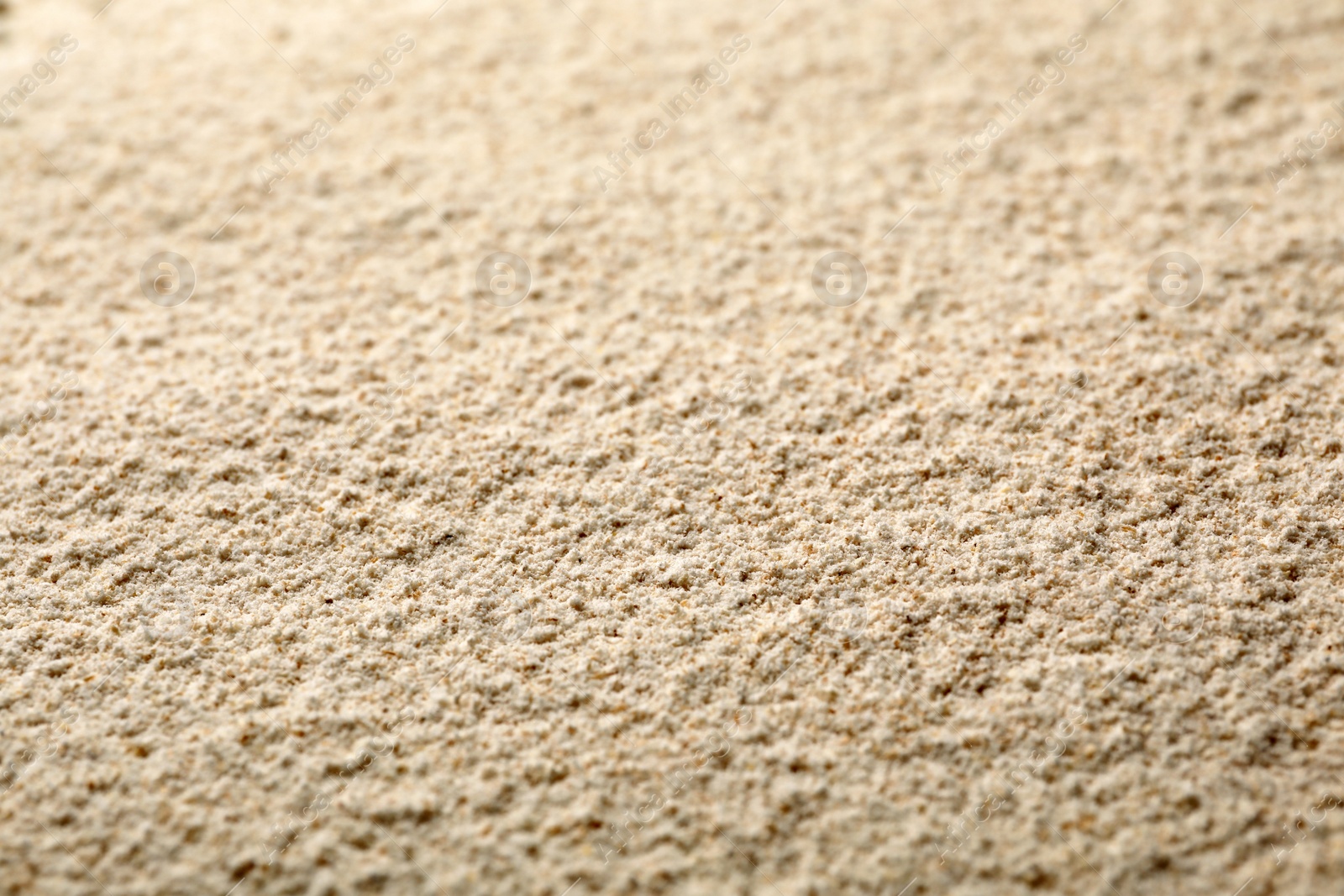 Photo of Sesame flour as background, closeup. Organic product