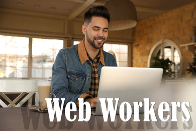 Image of Young man working with laptop at table in cafe. Web workers