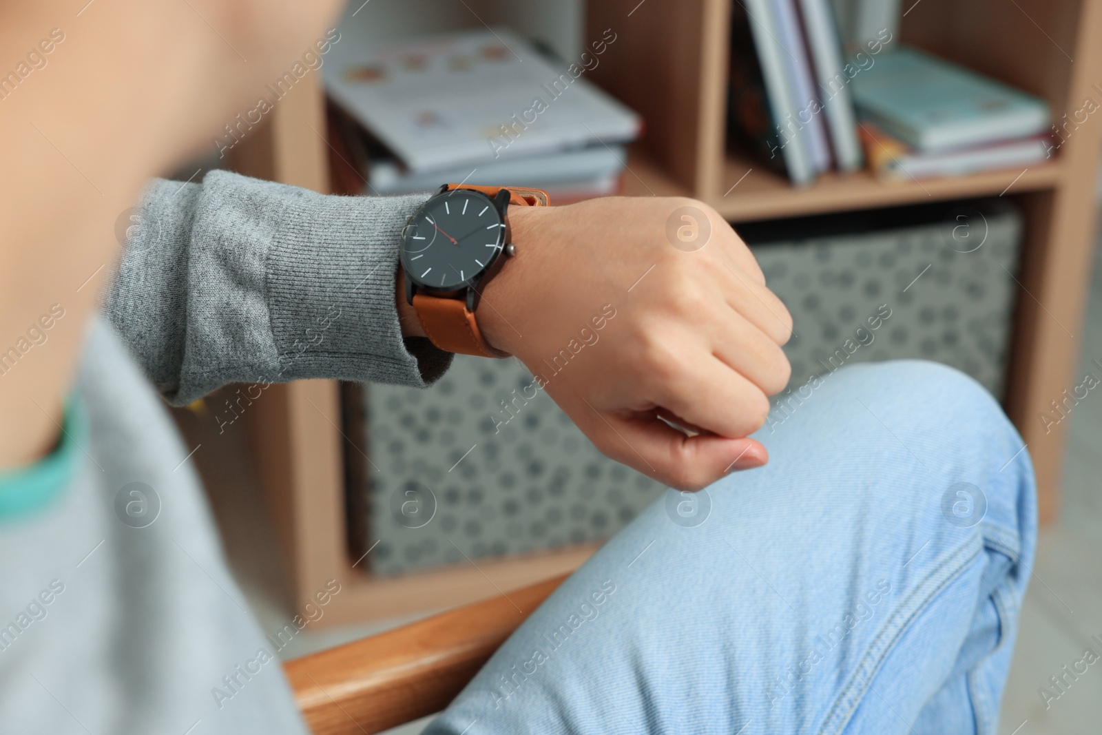 Photo of Man checking time in room, closeup. Being late