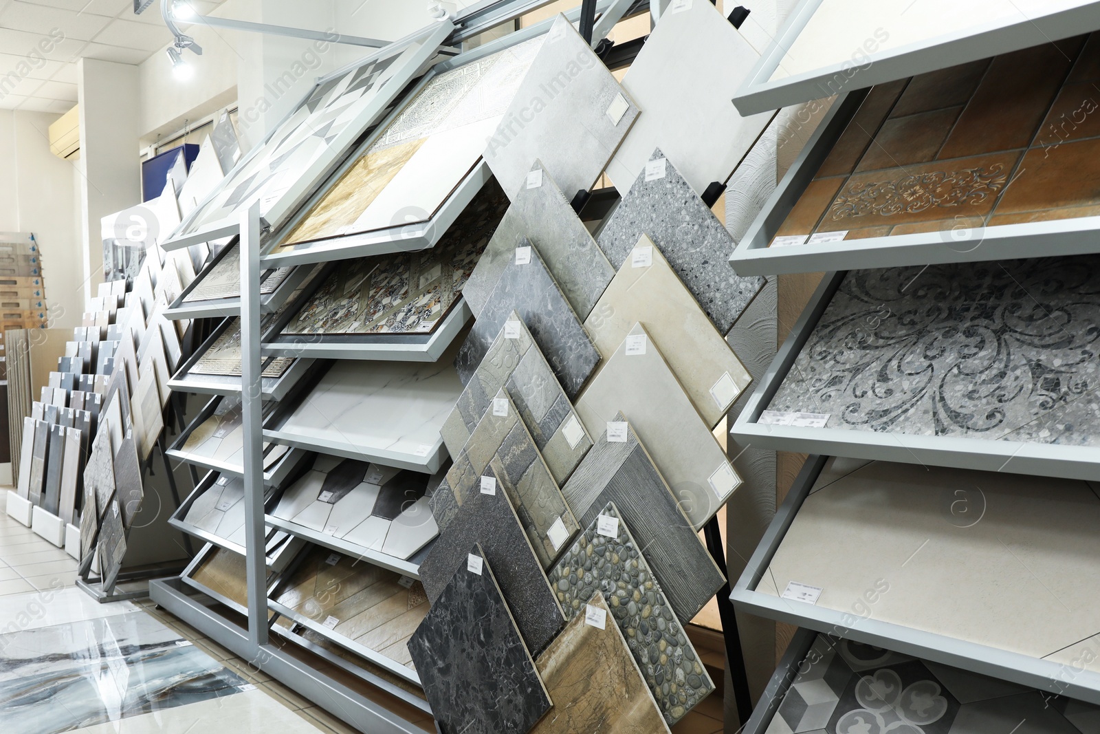 Photo of Assortment of tiles in store. Many different samples indoors