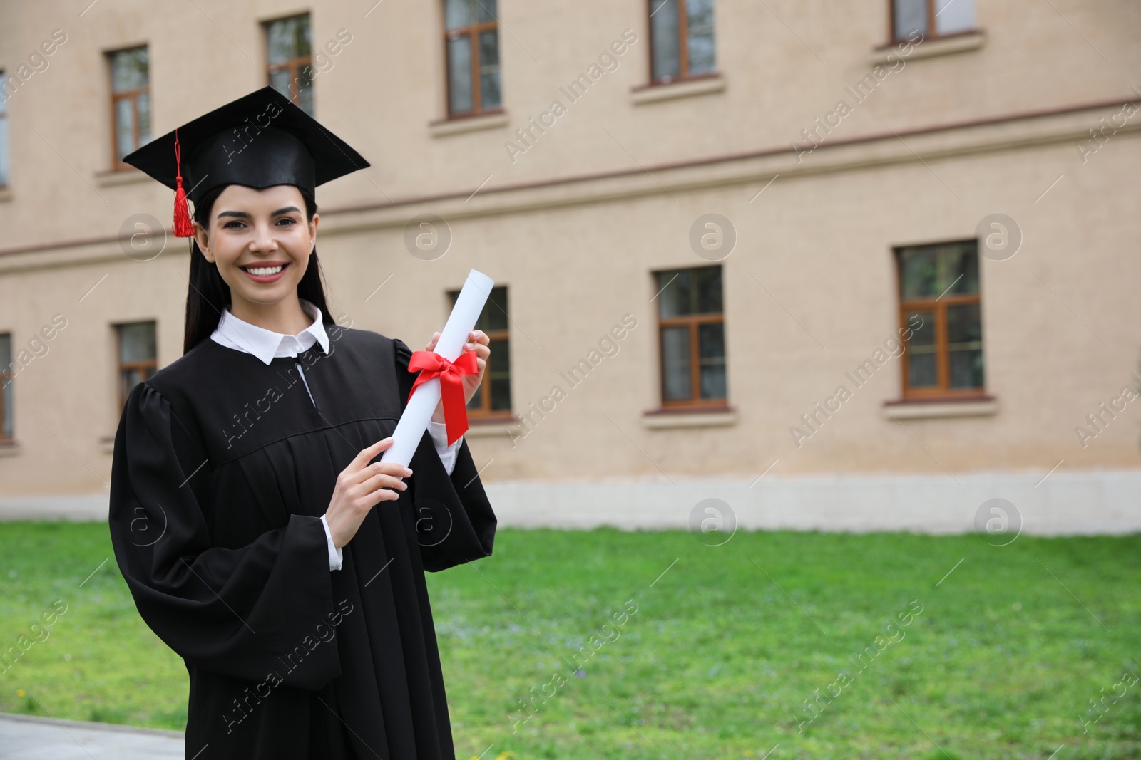 Photo of Happy student with diploma after graduation ceremony outdoors. Space for text