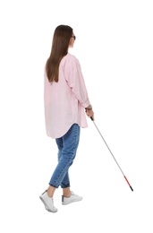 Blind woman with long cane on white background