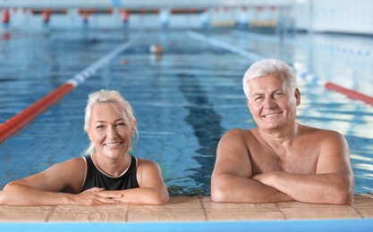 Photo of Sportive senior couple in indoor swimming pool