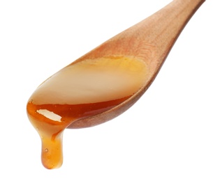 Photo of Honey dripping from spoon on white background