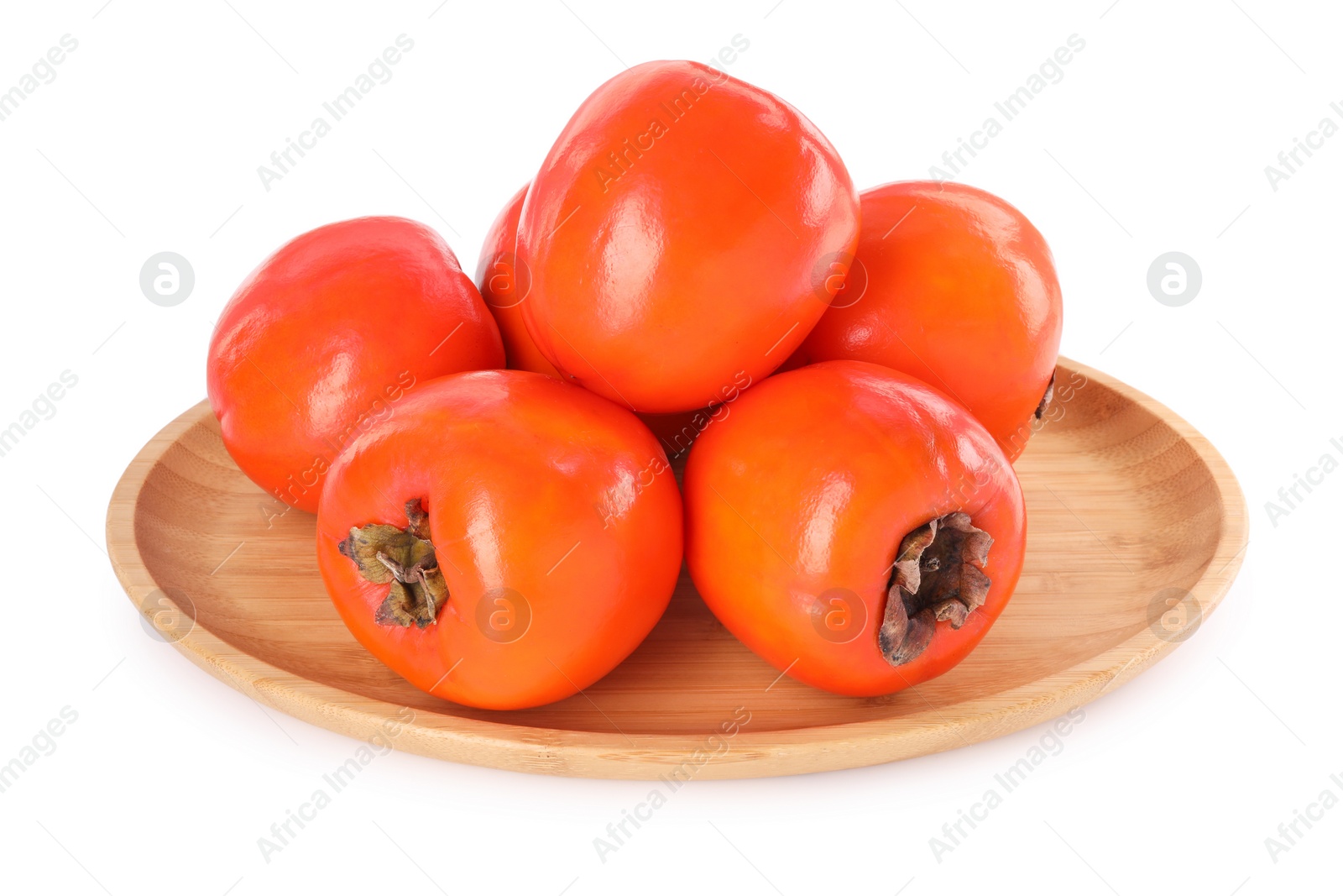 Photo of Delicious ripe juicy persimmons in wooden plate isolated on white