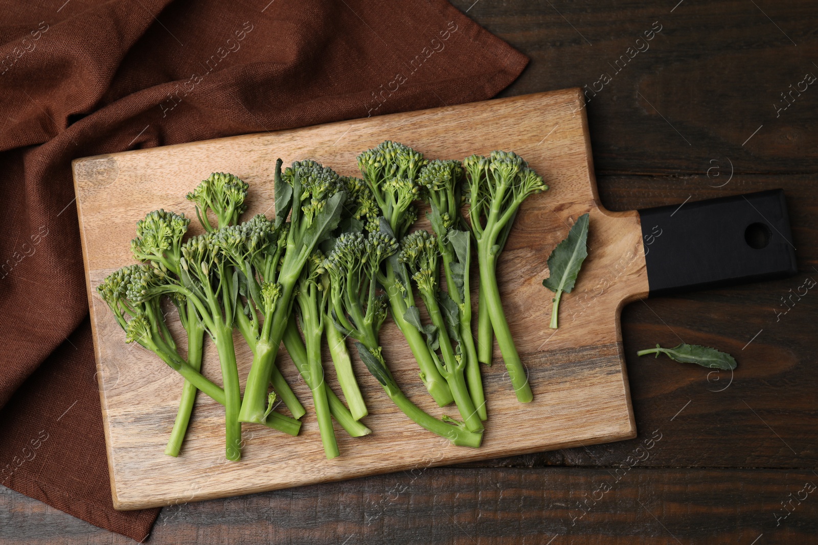 Photo of Fresh raw broccolini on wooden table, top view. Healthy food