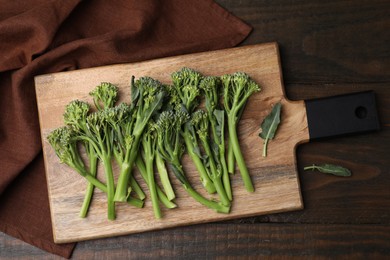 Fresh raw broccolini on wooden table, top view. Healthy food