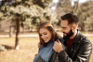 Photo of Portrait of cute young couple in park on sunny day