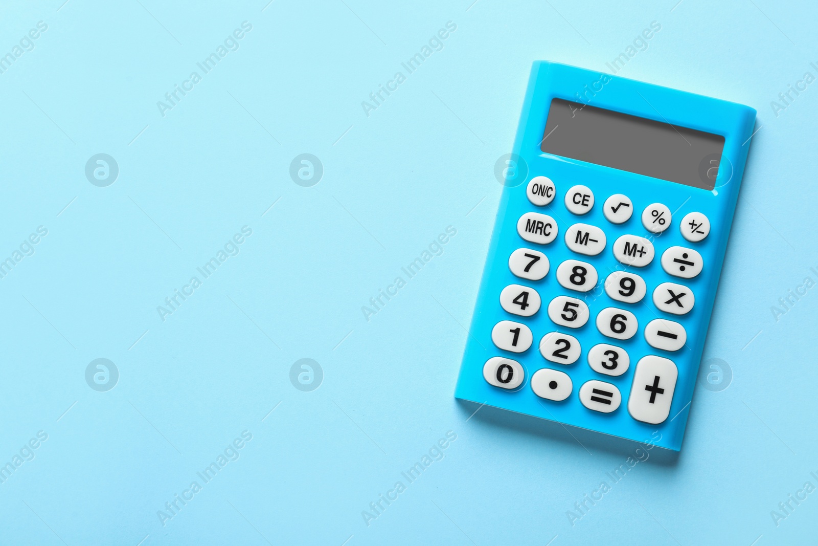 Photo of Light blue calculator on turquoise background, top view. Space for text