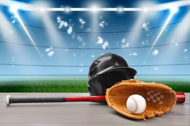 Image of Baseball bat, glove, helmet and ball on wooden table at stadium