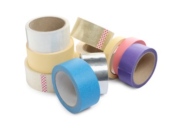 Many different rolls of adhesive tape on white background