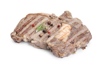 Piece of delicious grilled beef meat, rosemary and peppercorns isolated on white