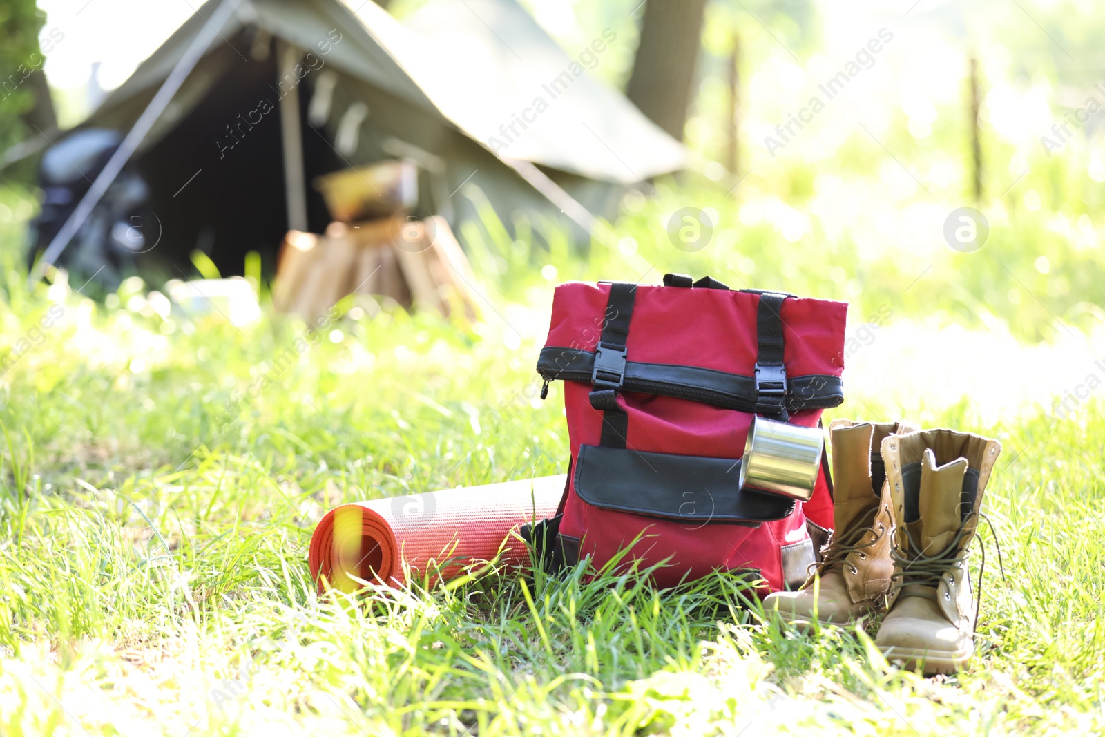 Photo of Traveling gear near tent outdoors. Summer camp