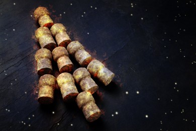 Christmas tree made of sparkling wine corks on black background