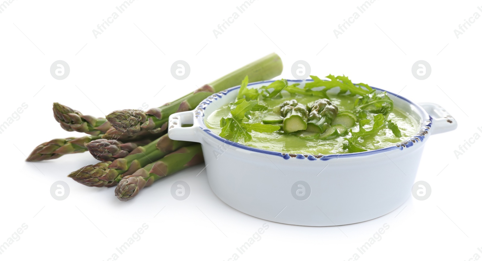 Photo of Delicious asparagus soup with arugula isolated on white