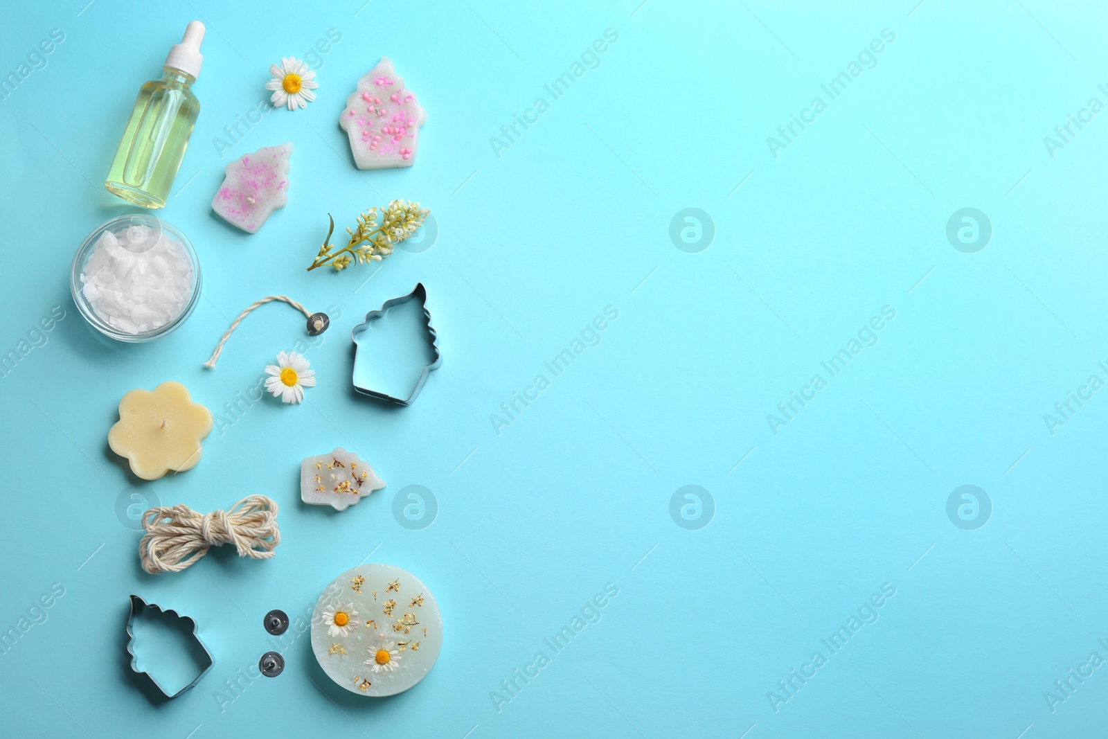 Photo of Flat lay composition with handmade candles and tools on color background. Space for text