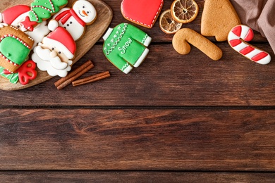 Photo of Flat lay composition with delicious homemade Christmas cookies on wooden table. Space for text