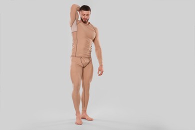 Photo of Man in warm thermal underwear on light background