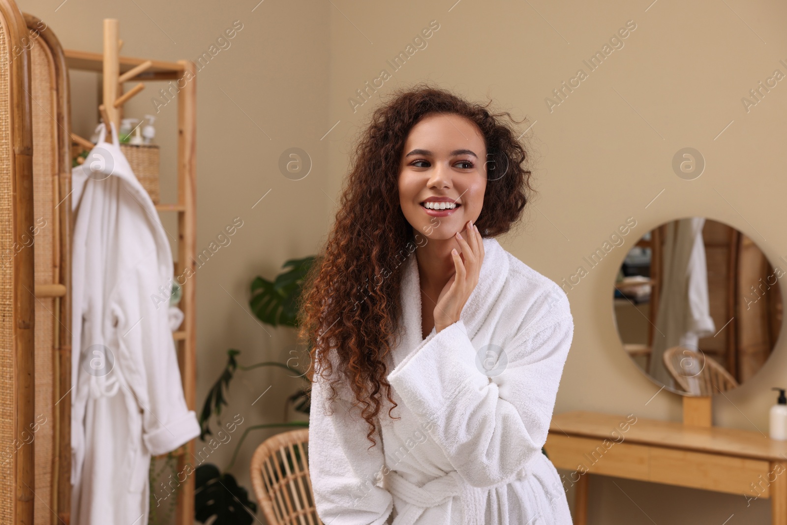 Photo of Beautiful African American woman in bathrobe at home