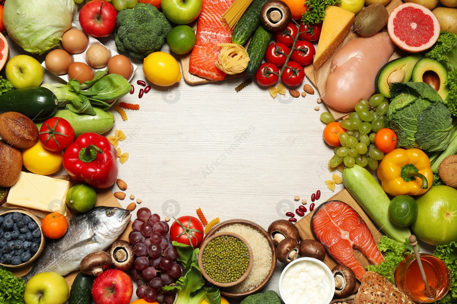 Photo of Frame of different food products on wooden table, flat lay with space for text. Healthy balanced diet