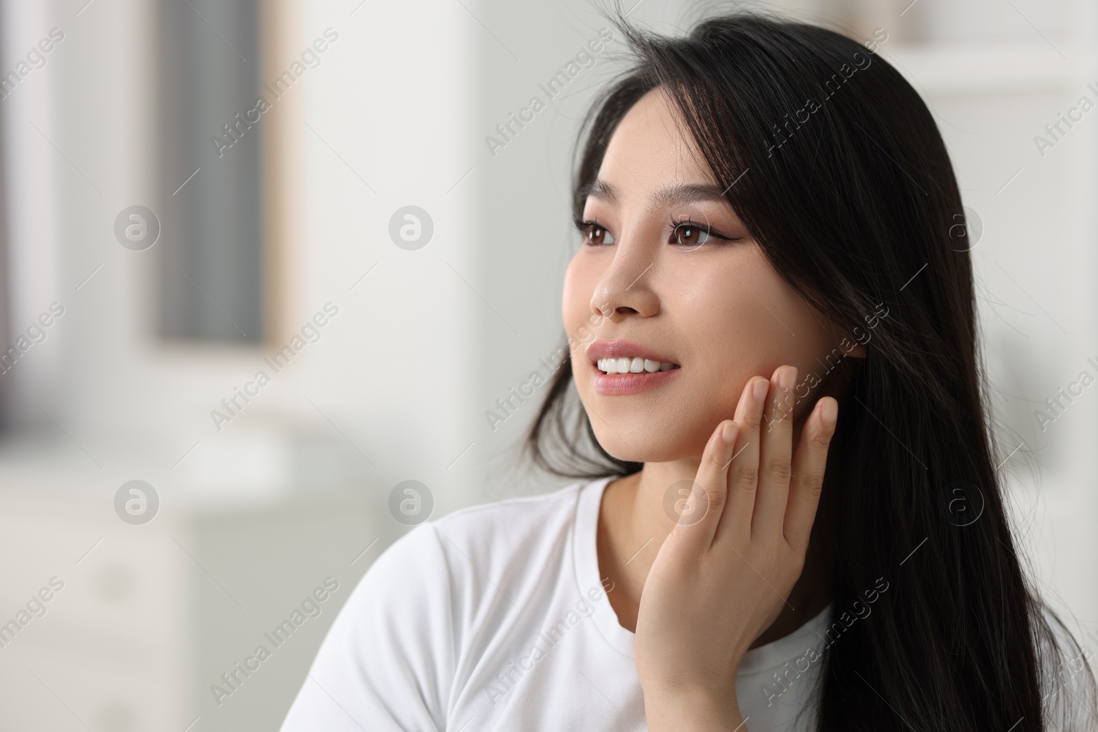 Photo of Portrait of beautiful woman with perfect skin at home, space for text