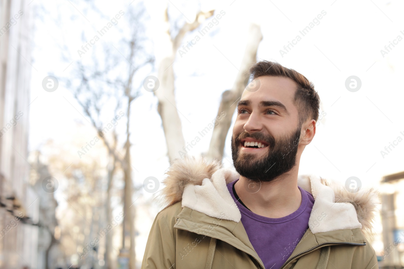 Photo of Portrait of handsome young man on city street