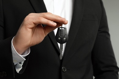 Young man holding new car key, closeup