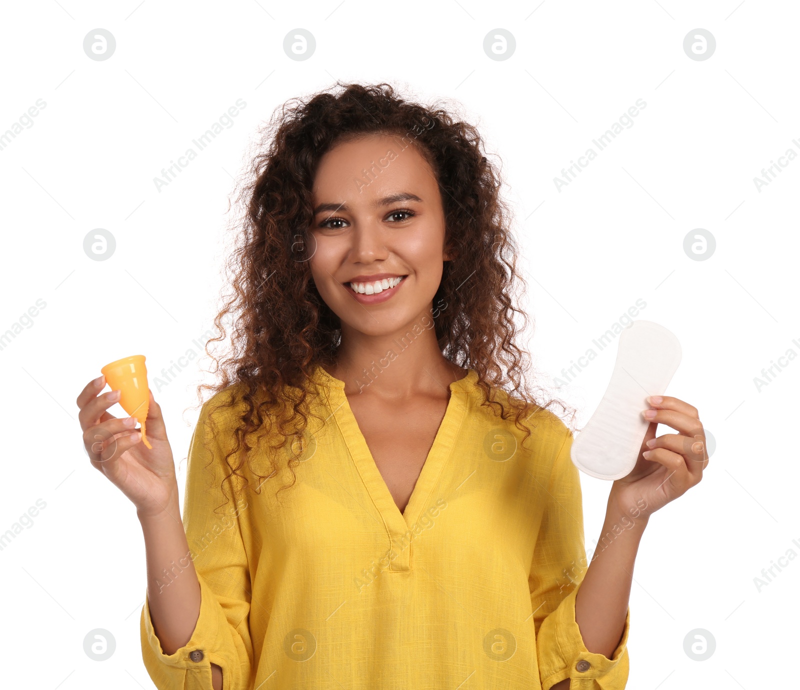 Photo of Young African American woman with menstrual cup and pantyliner on white background