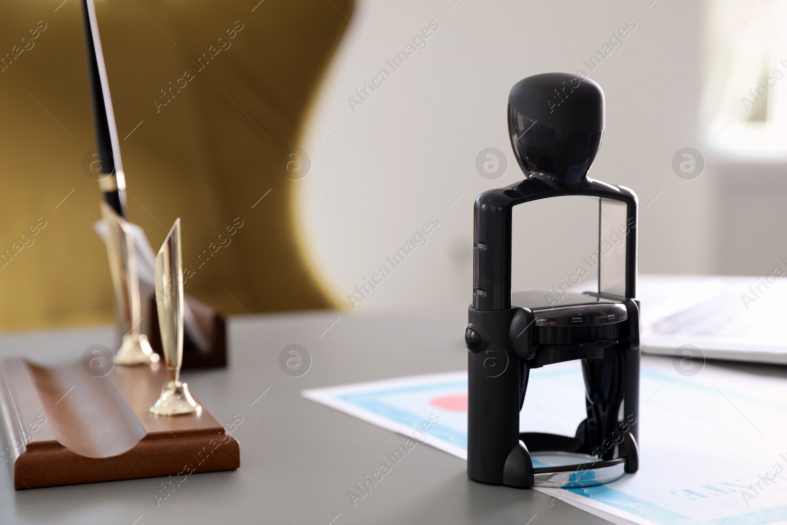 Photo of Automatic stamp and documents on desk in notary's office