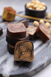 Photo of Tasty chocolate candies on table, closeup view