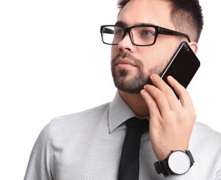 Young businessman talking on smartphone against white background