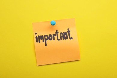 Photo of Paper note with word Important pinned on yellow background