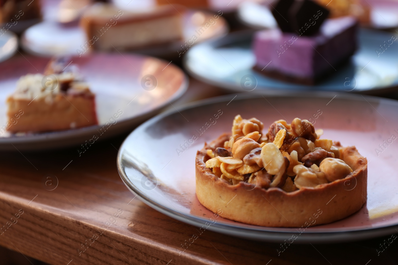 Photo of Plate with delicious cake on wooden table