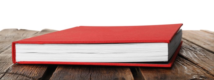 Photo of Book with red cover on wooden table against white background