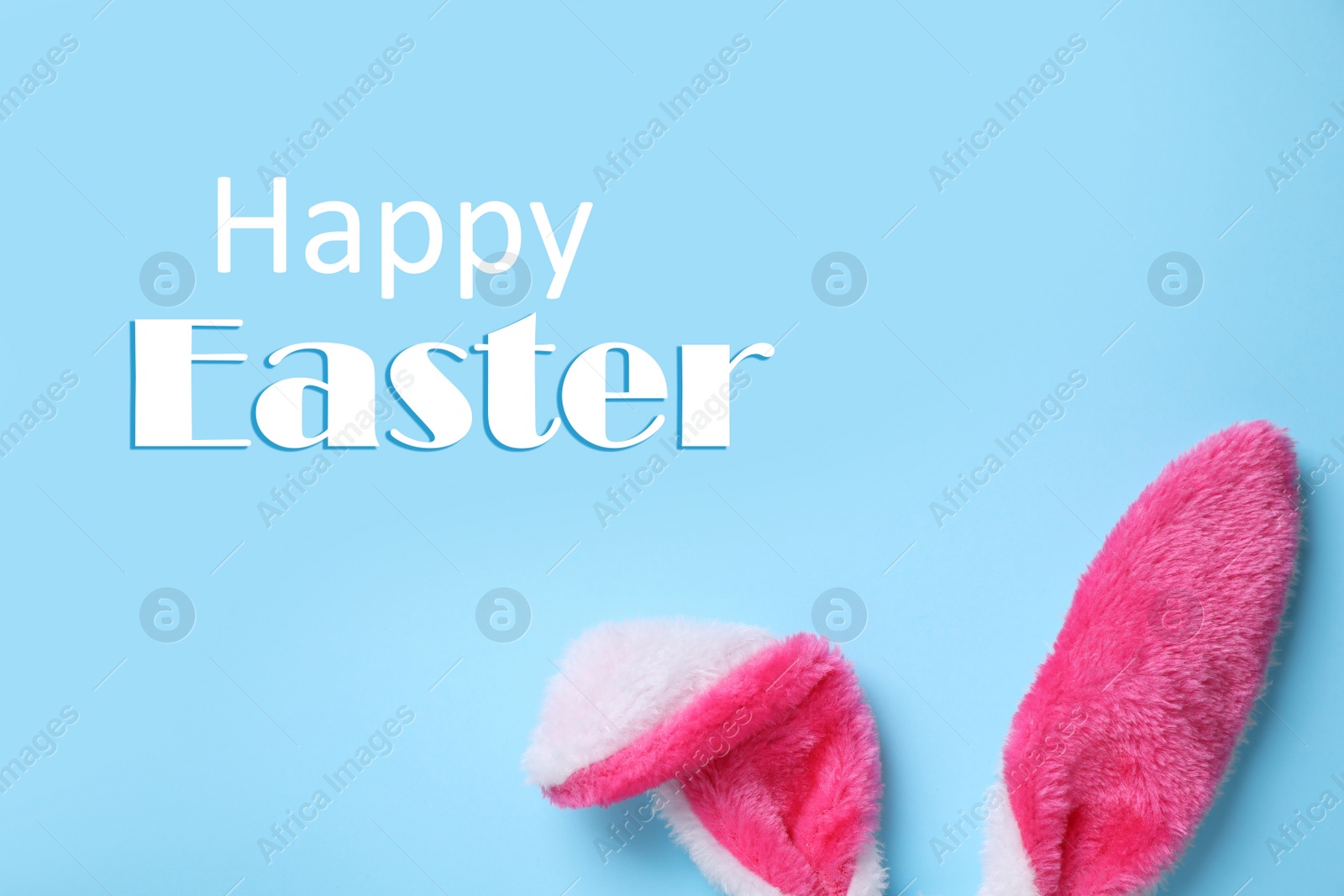 Image of Decorative Easter bunny ears on light blue background, flat lay