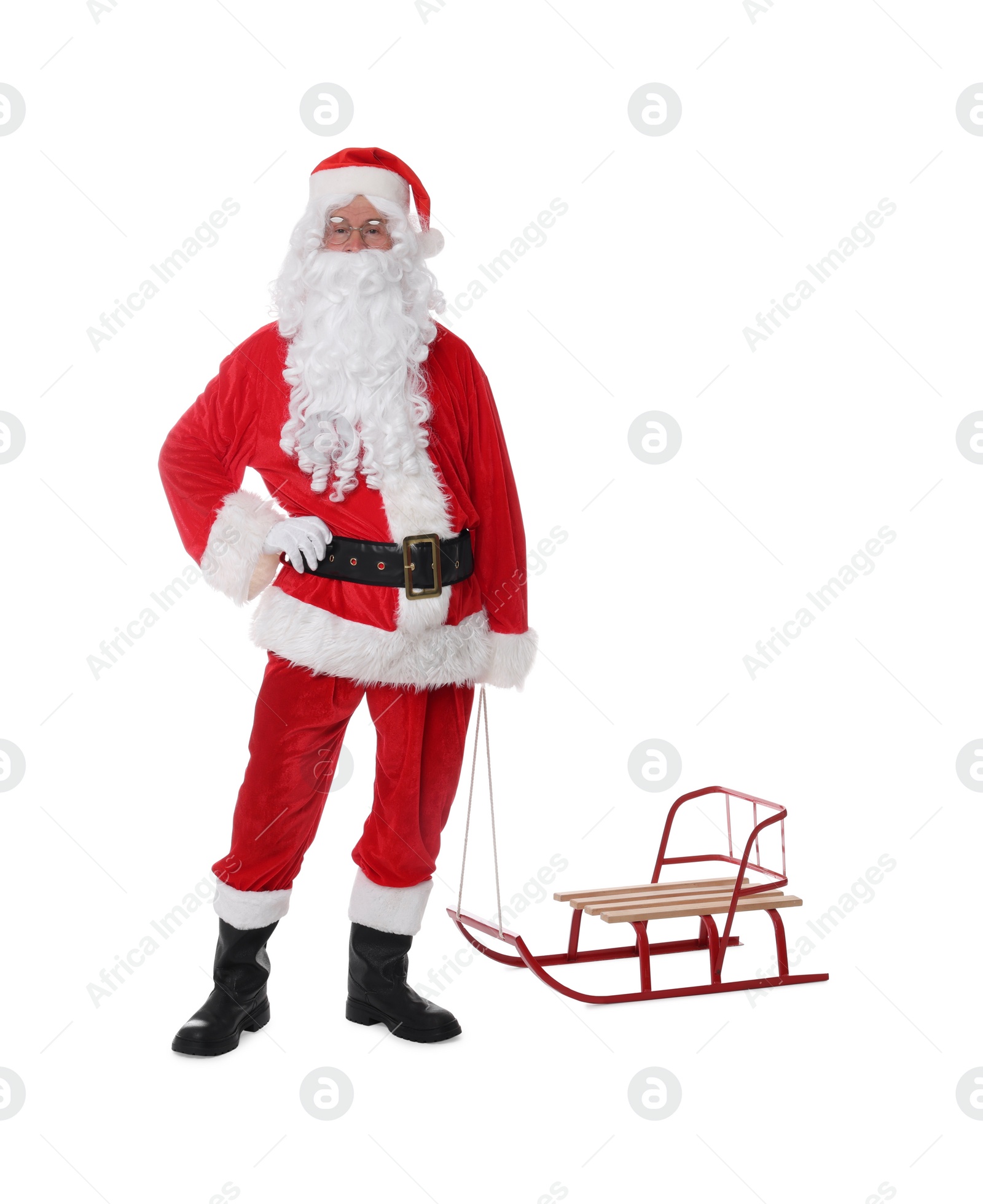 Photo of Man in Santa Claus costume with sleigh posing on white background