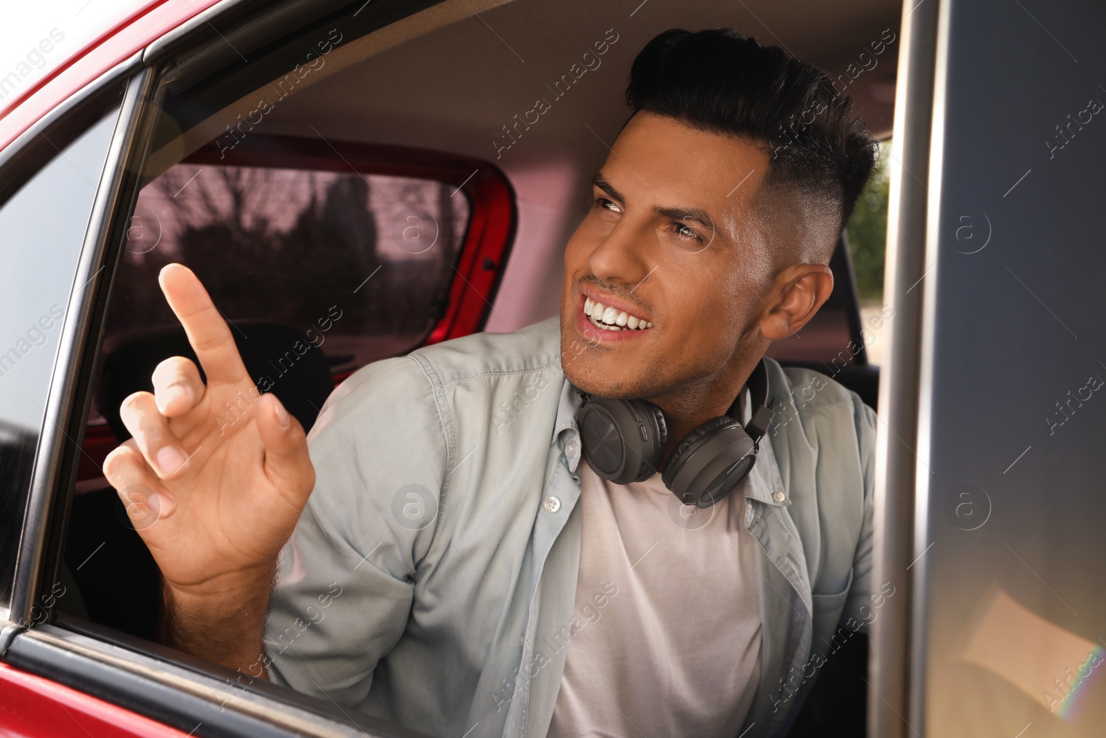 Photo of Man looking out of taxi window outdoors