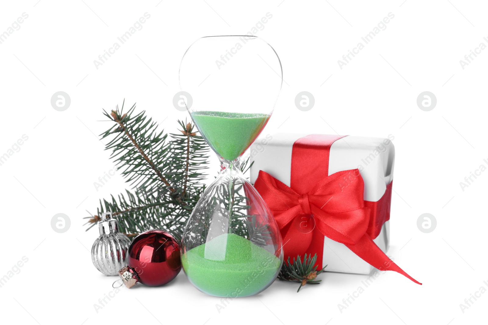 Photo of Hourglass, gift and fir tree twig with balls on white background. Christmas countdown