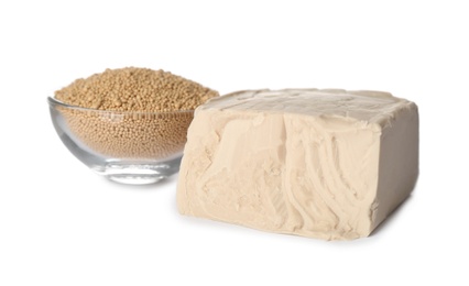 Compressed and granulated yeast on white background