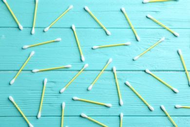 Flat lay composition with cotton swabs on wooden background