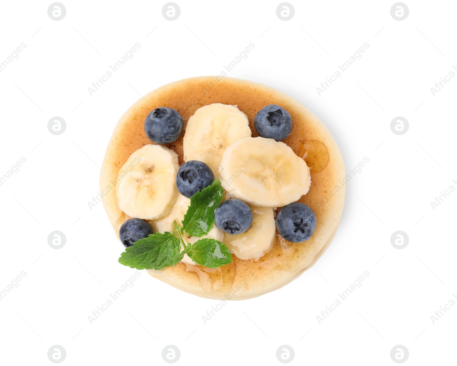 Photo of Delicious pancake with banana slices, blueberries and mint isolated on white, top view