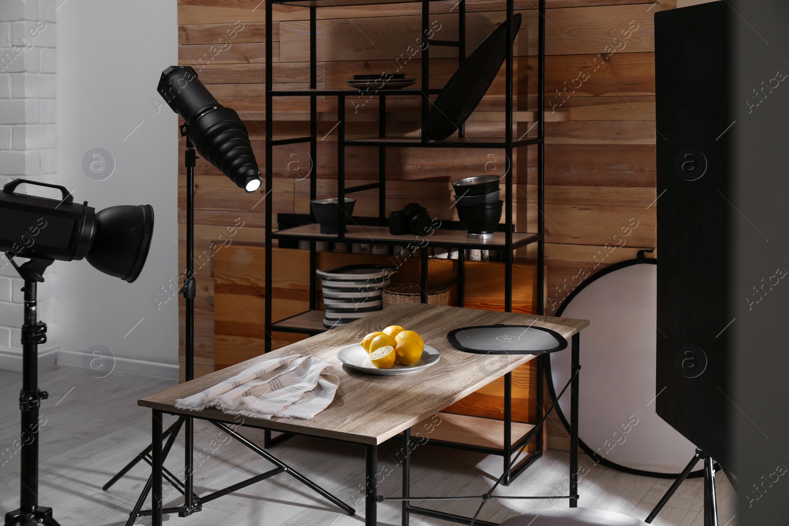 Photo of Professional equipment and many lemons on table in studio. Food photo