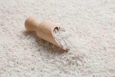 Photo of Raw basmati rice and scoop, closeup view