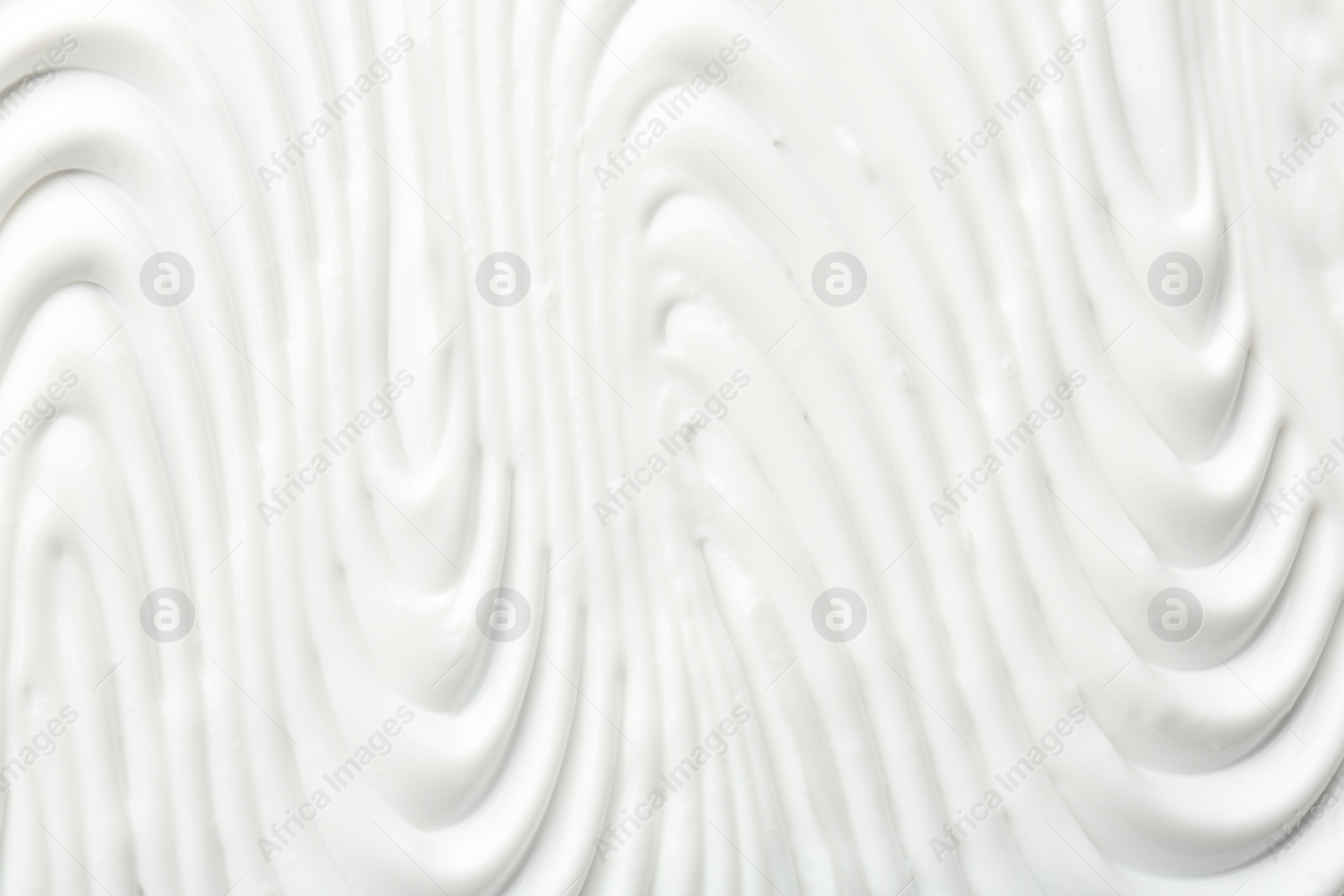 Photo of Texture of face care cream as background, top view