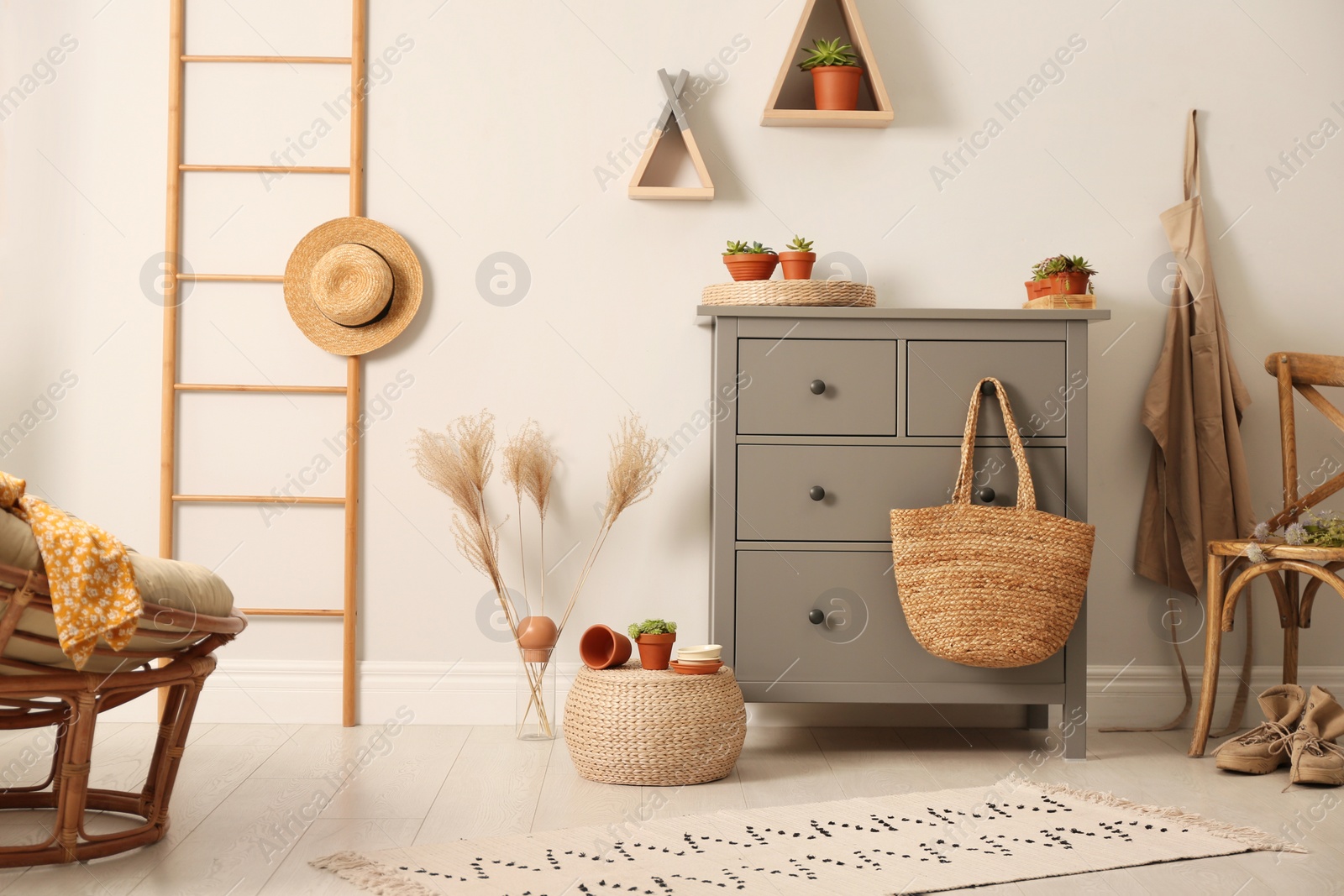 Photo of Grey chest of drawers in stylish room interior